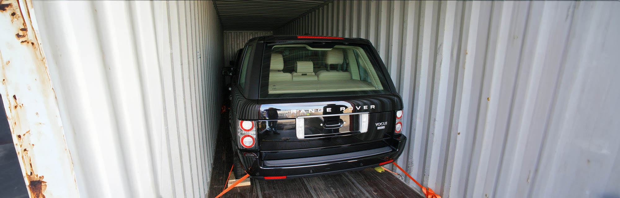 A black Range Rover secured inside a shipping container, demonstrating the professional export services at Icon Servicing.