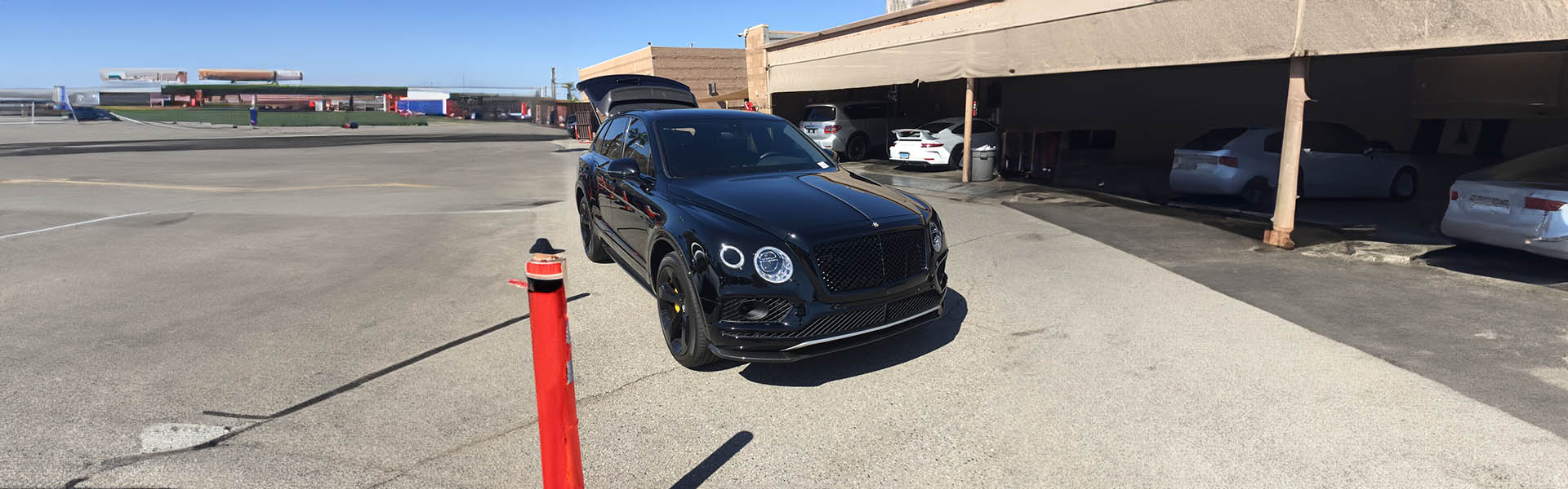 Black Bentley Bentayga parked at a dealership