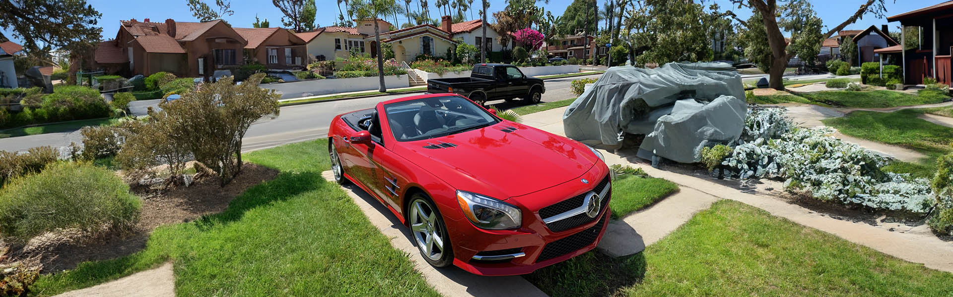 Red Mercedes-Benz convertible parked in a residential neighborhood